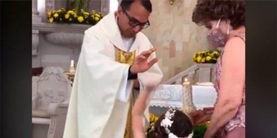 &iexcl;Сhoca esos cinco!: la sorprendente reacci&oacute;n de la ni&ntilde;a mientras la bendice el cura
